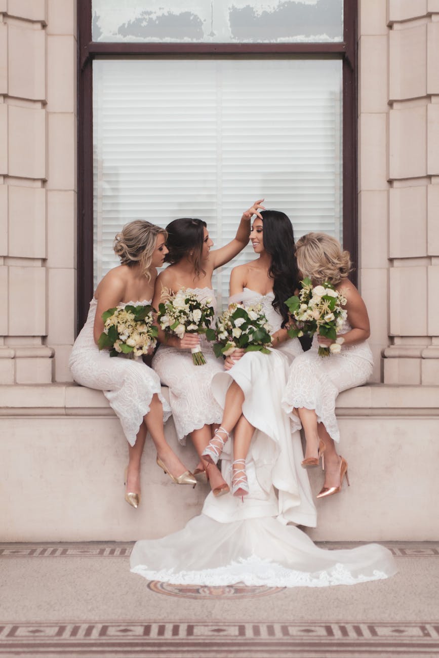 Bride and bridesmaids elegantly posed with bouquets in Melbourne, Australia.